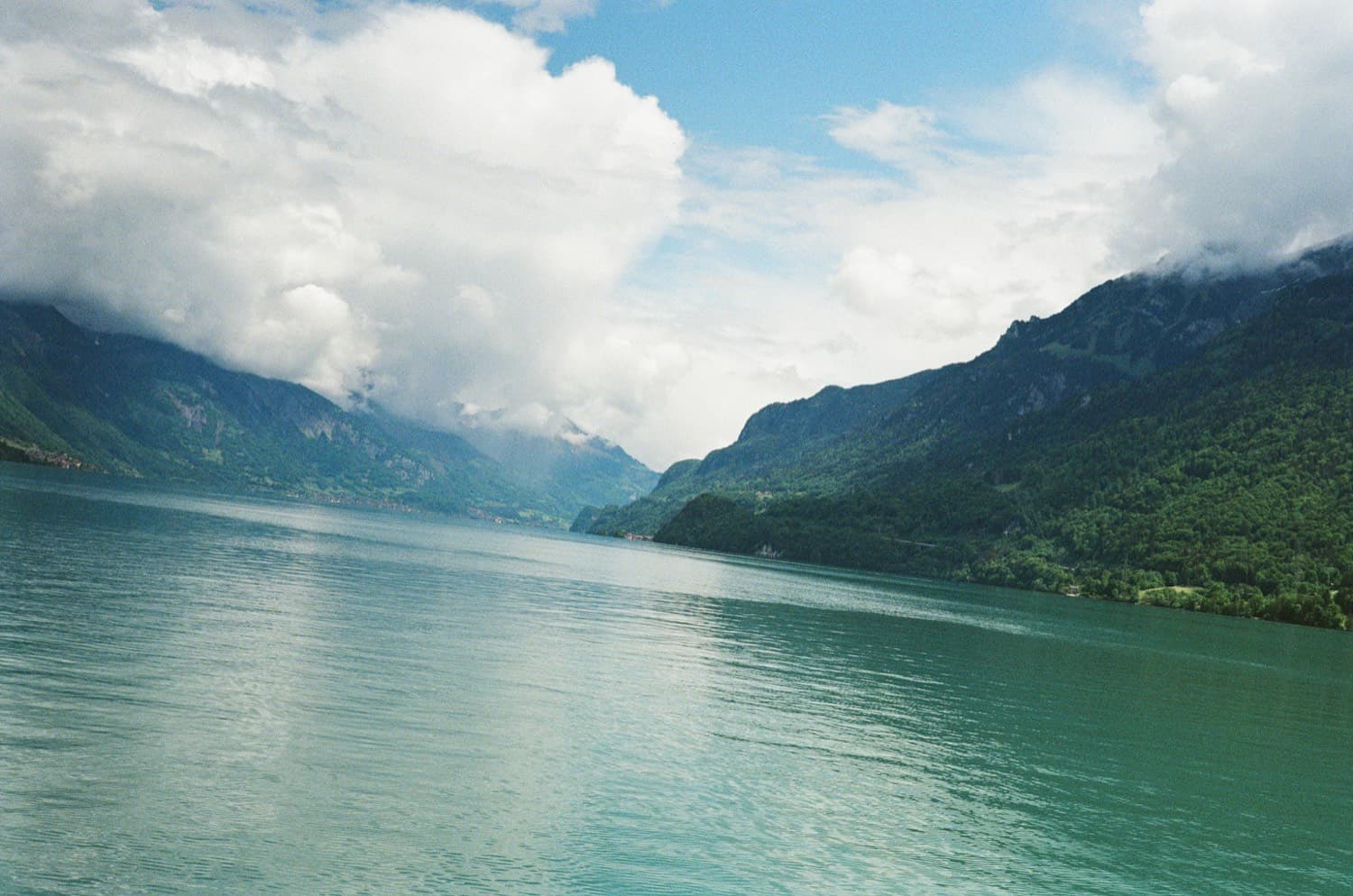 Mountain ridges beyond a quiet alpine lake